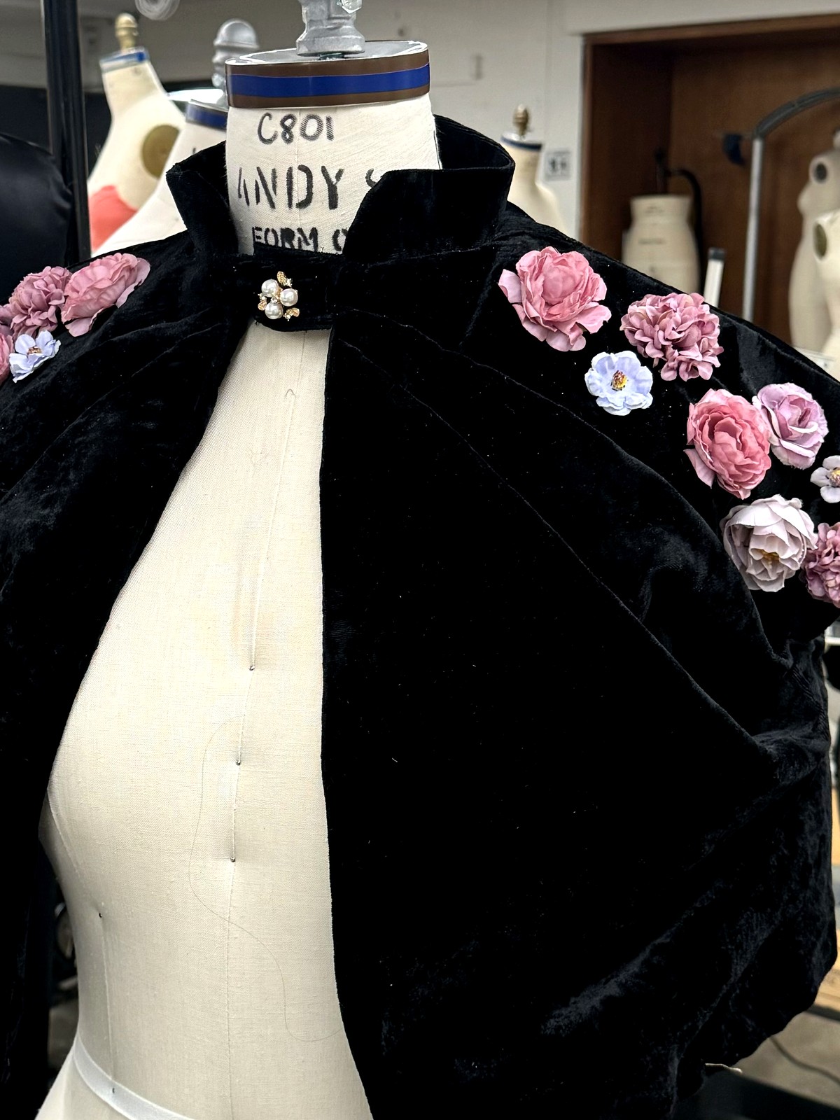 Black velvet capelet embroidered with hand-made silk flowers at the shoulders